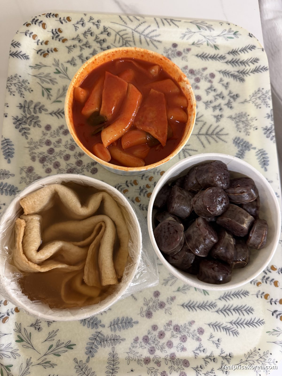 Takeout set: tteokbokki (spicy rice cakes), sundae (Korean blood sausage), and eomuk (fish cake) with broth